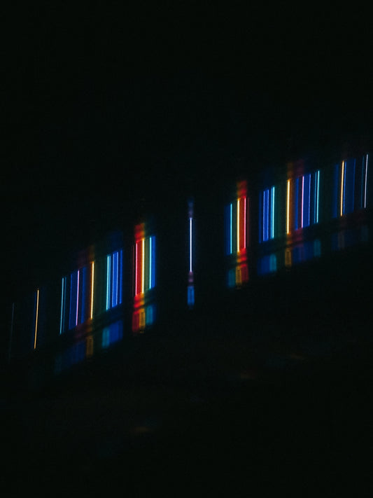 a dark room with some lights on the wall